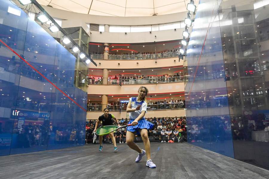 Egypt's Kenzy Ayman plays against Malaysia's Xin Ying Yee (front) during the Finals match of SDAT WSF Squash World Cup held in Chennai. - AFP pic