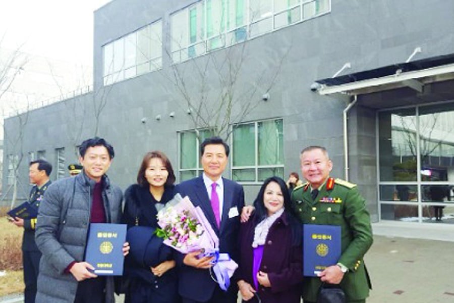 The writer (right) with his close friend and coursemate, Lee Young Kwan (centre), at the Korea National Defence University’s convocation on Dec 7, 2017. - Pic courtesy of writer