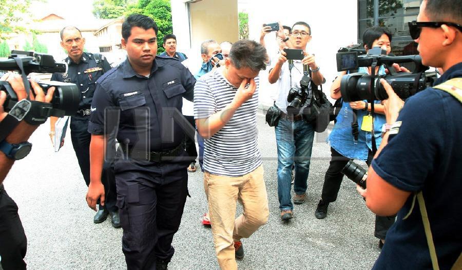 Teh Kim Huat, 49 (centre) at George Town Sessions Court today. Pix by Danial Saad