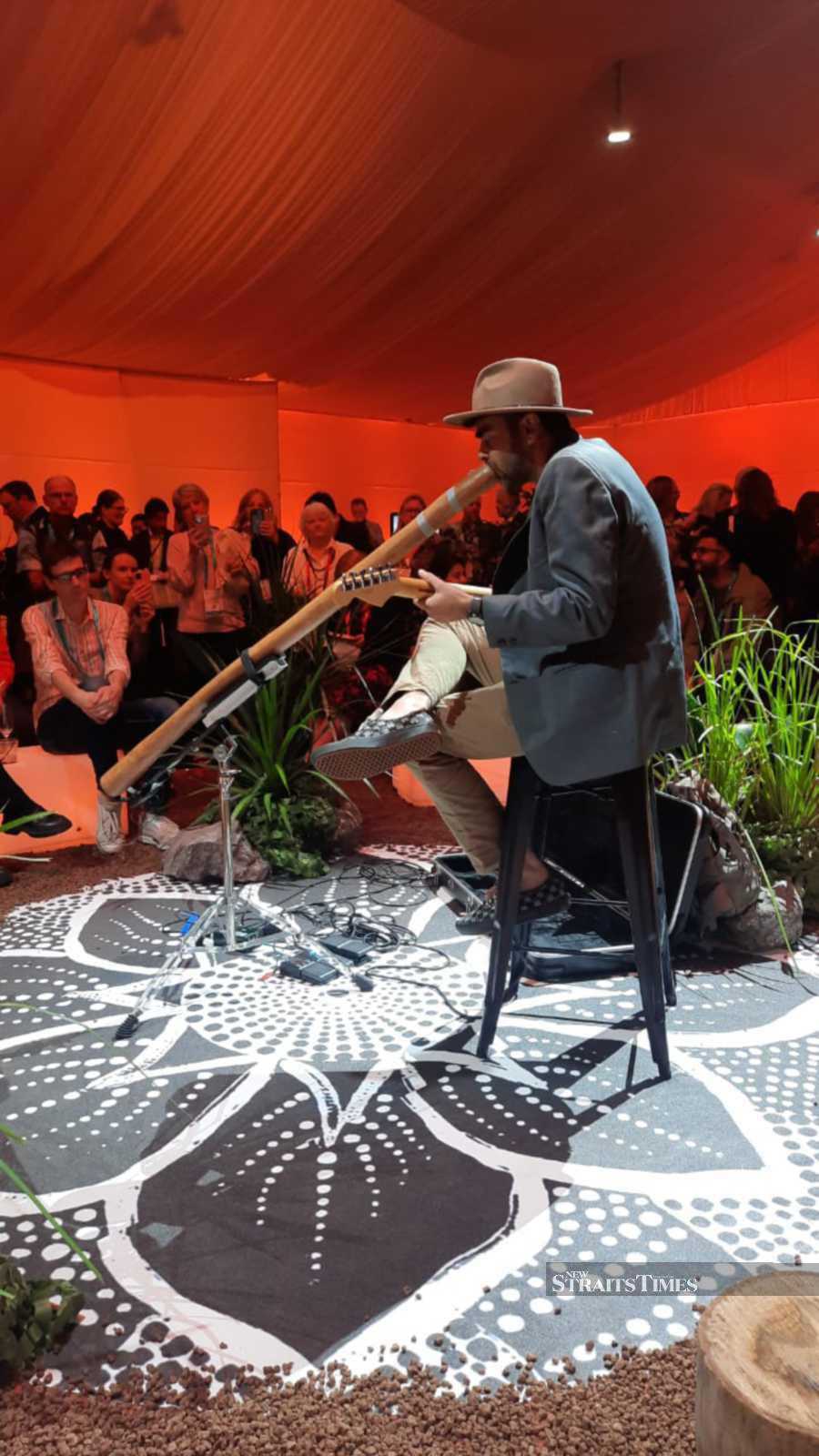 Enchanting...an aboriginal musician performing with the didgeridoo.