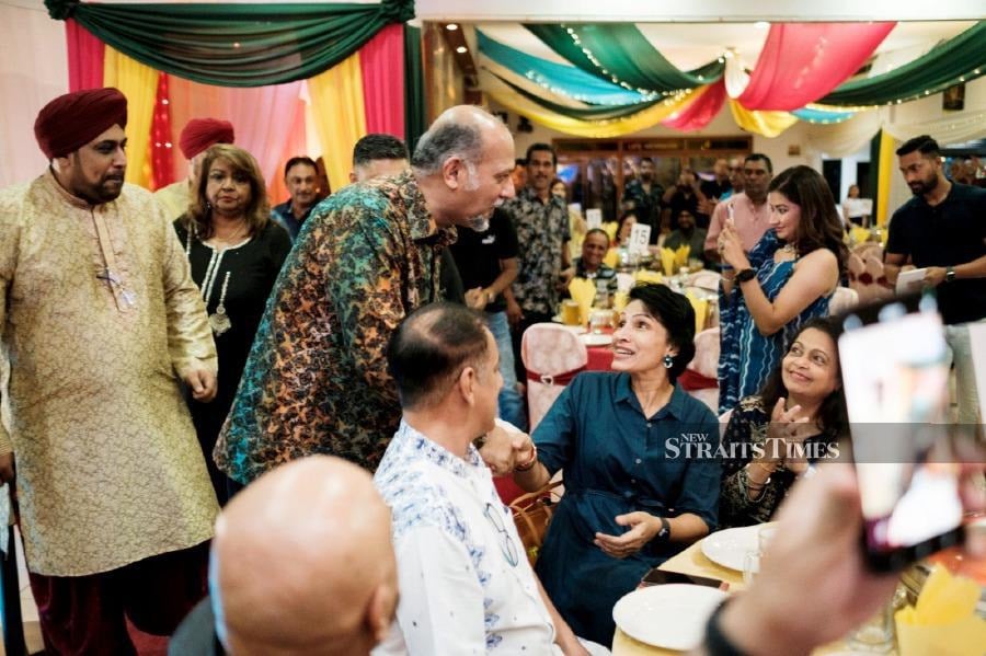 Gobind chatting with some guests at the Vaisakhi Dinner and Dance event. -- NSTP/MOHAMAD SHAHRIL BADRI