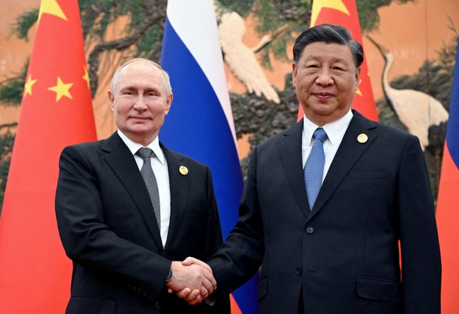 Russian President Vladimir Putin shakes hands with Chinese President Xi Jinping during a meeting at the Belt and Road Forum in Beijing, China, Oct 18, 2023. Reuters File Pic.