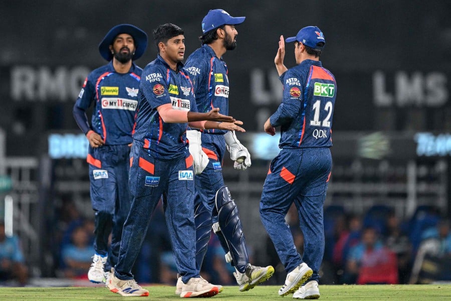 Lucknow Super Giants' Yash Thakur (2 left) celebrates with teammates after taking the wicket of Gujarat Titans' Vijay Shankar during the Indian Premier League (IPL) Twenty20 cricket match between Lucknow Super Giants and Gujarat Titans at the Ekana Cricket Stadium in Lucknow.- AFP