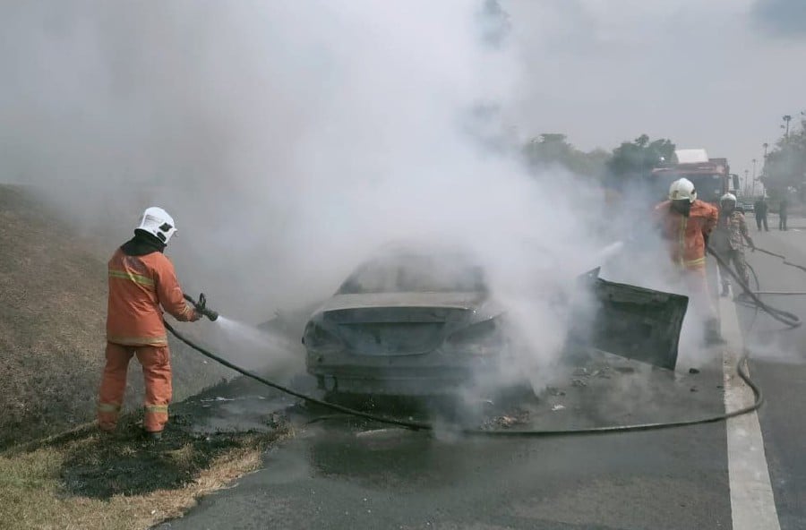 The firefighters extinguished a fire involving a Mercedes Benz CFA 200 car that was destroyed in a fire at Kilometer 82.0 of the North-South Expressway, Gurun. PIC COURTESY OF FIRE & RESCUE DEPT