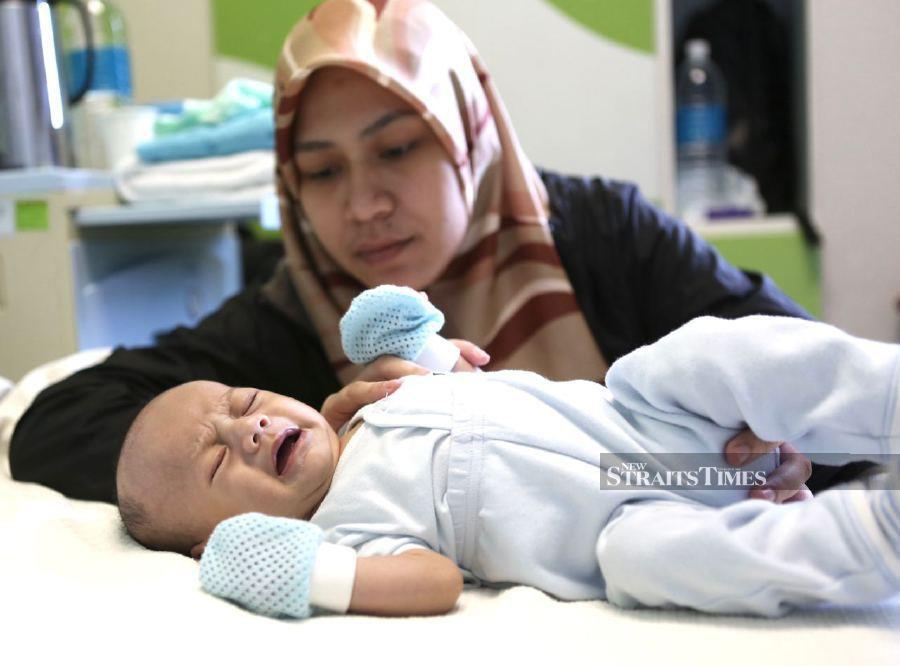Farajihan Mardhiah Abd Wahab with her baby Muhammad Adam Naufal Muhammad Asyraf, at Gleneagles Hospital in Kuala Lumpur. -NSTP/AMIRUDIN SAHIB.