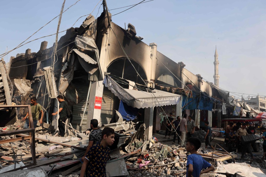 People check the destruction following Israeli strikes on Al-Shatee camp in Gaza City. - AFP PIC