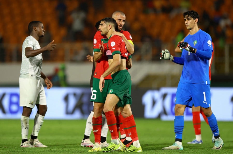 Morocco's Achraf Hakimi and Romain Saiss look dejected after the match. - REUTERS pic