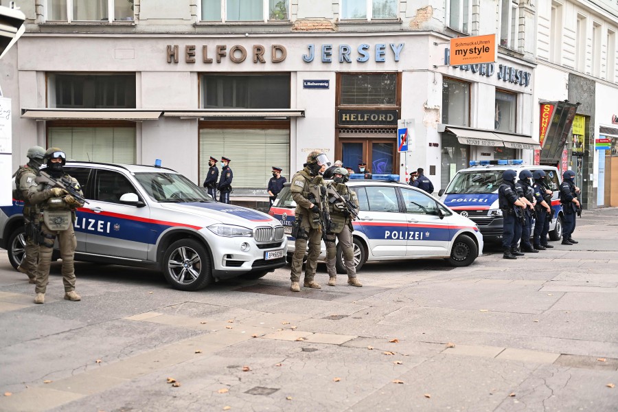 Policemen secure the area around a crime scene in Vienna. - AFP pic