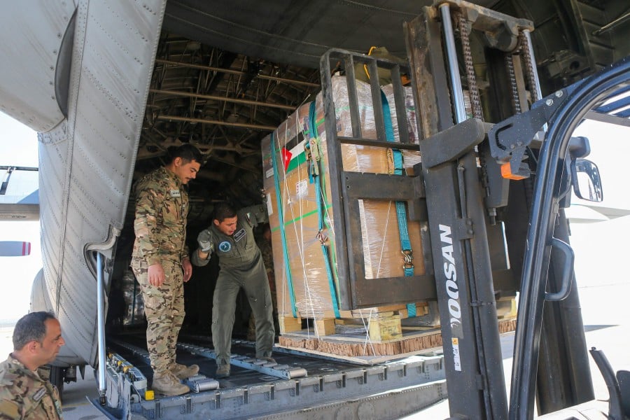 Humanitarian aid for Palestinians in the Gaza Strip is loaded onto a Jordanian Air Force aircraft in Amman. Humanitarian organisation Doctors Without Borders says United States plans to build a temporary floating pier in Gaza to increase the flow of humanitarian aid was merely a distraction from the real issue. AFP pic