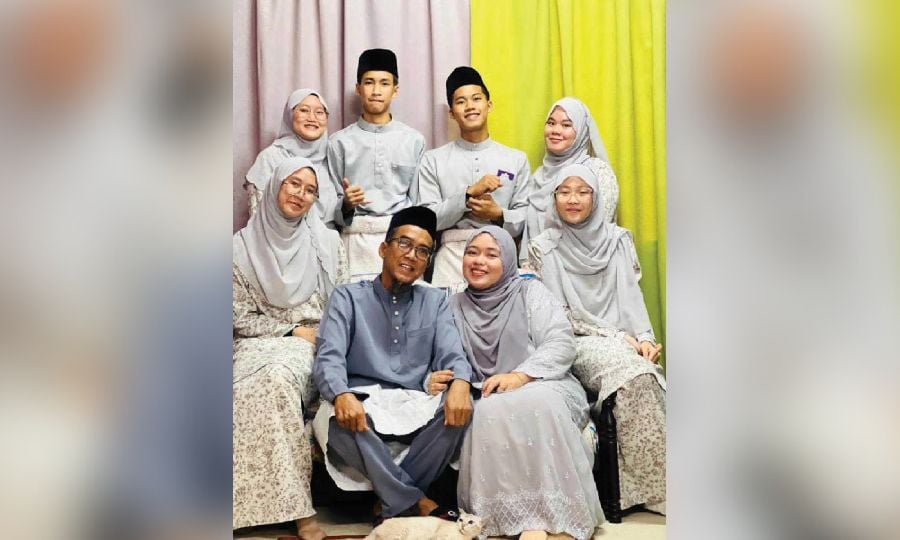 Aisyah Mahamad Zainal with her husband Muhamad Muzzamil Katemon and their children. 