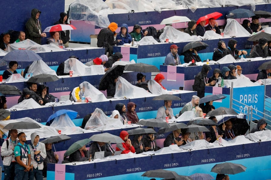 Rainy Paris Olympic parade dampens many spectators' spirits