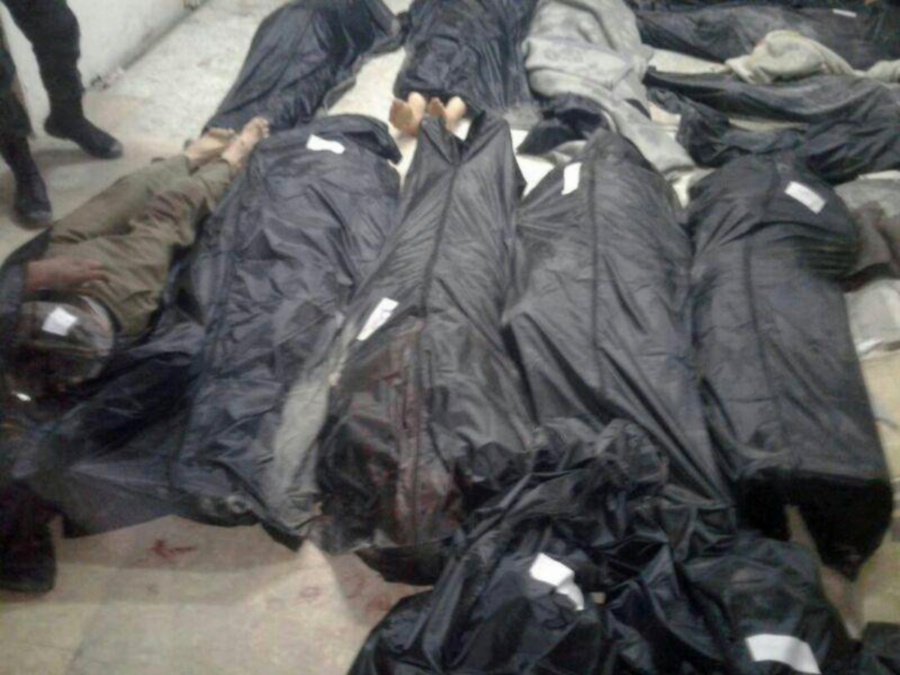 Covered dead bodies lie on the ground after Islamic State fighters killed 20 people in the village of Aqarib al-Safi, east of Hama city, Syria in this handout picture provided by SANA on May 18, 2017. SANA/Handout via REUTERS