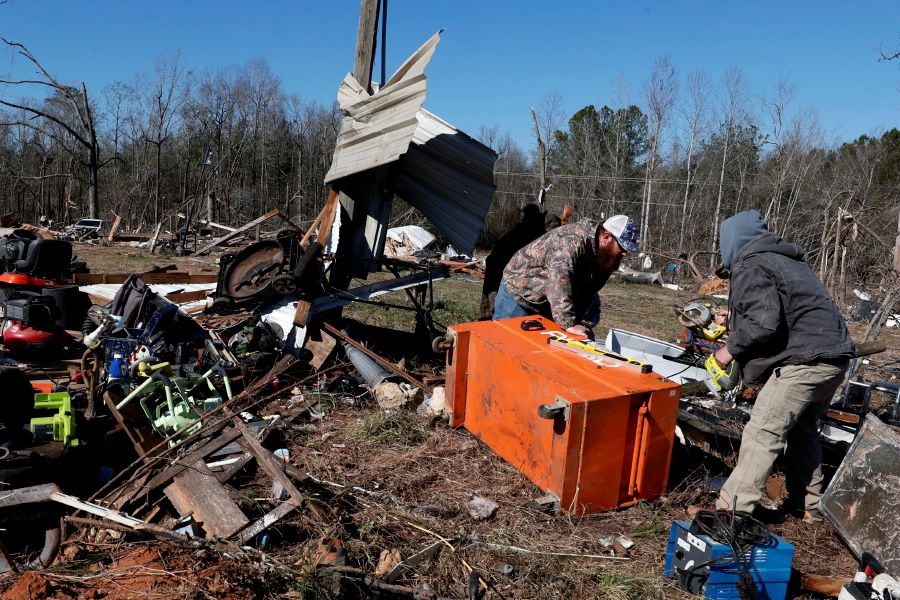 Friends and family help sift through debris looking for personal items as they recover from a tornado that ripped through Central Alabama earlier this week Saturday, in Marbury, Ala. - AP pic