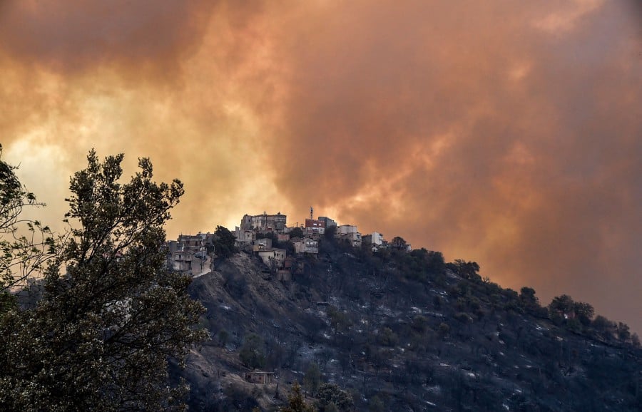 Smoke rises from a wildfire in the forested hills of the Kabylie region, east of the capital Algiers. - AFP PIC