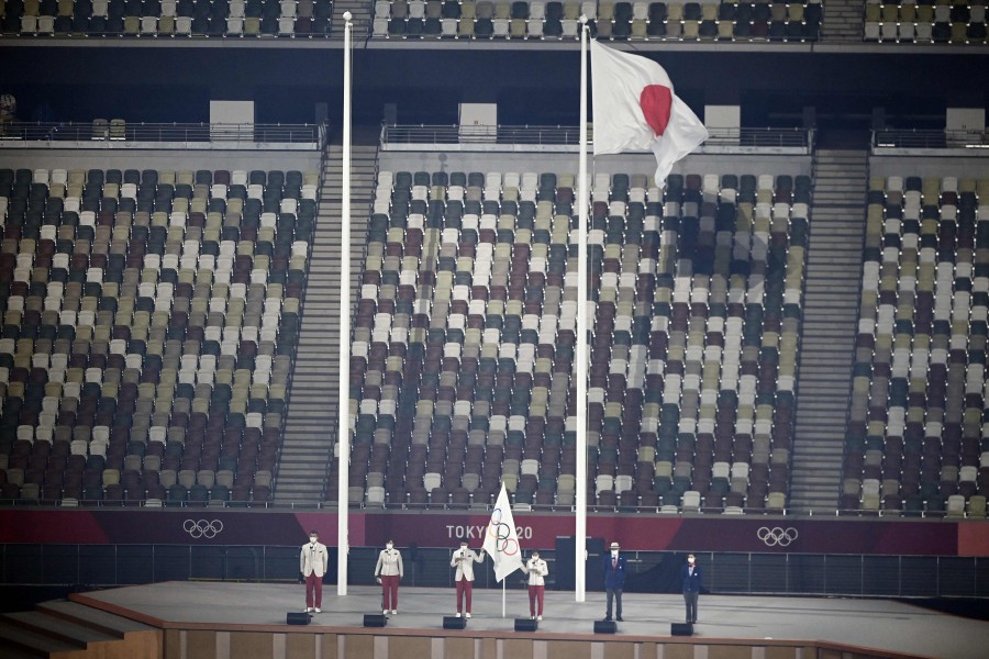 The Olympic flag is held as the Olympic Oath is read during the opening ceremony of the Tokyo 2020 Olympic Games, at the Olympic Stadium, in Tokyo. - AFP Pic