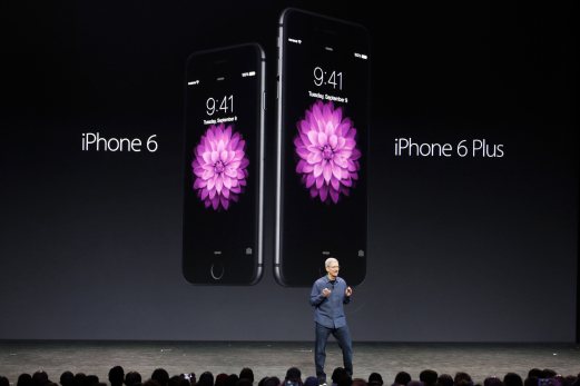 Apple CEO Tim Cook introduces the new iPhone 6 and iPhone 6 Plus (R) during an Apple event at the Flint Center in Cupertino, California, September 9, 2014. REUTERS Photo