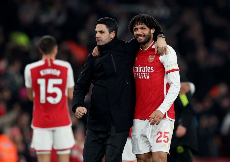 Arsenal manager Mikel Arteta and Mohamed Elneny celebrate after the match. - REUTERS PIC