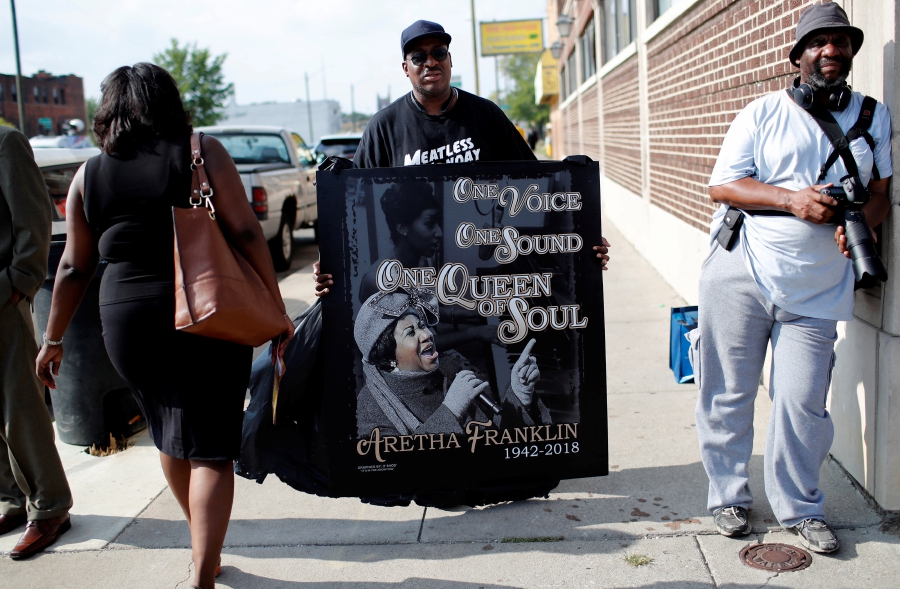 A man holds a sign outside the New Bethel Baptist Church before a gospel tribute concert to late singer Aretha Franklin at in Detroit, Michigan. REUETRS