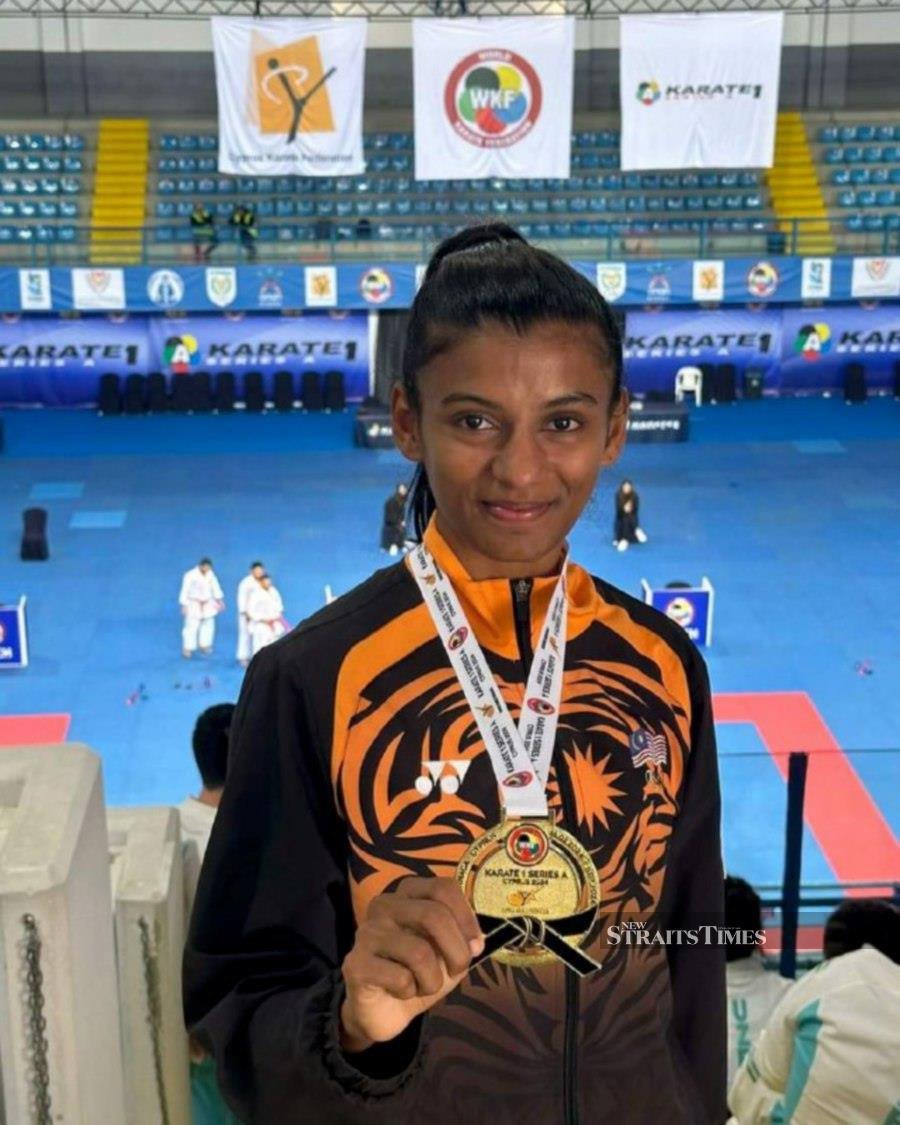 C. Shahmalarani with her gold medal at the Karate K1 Serie A in 