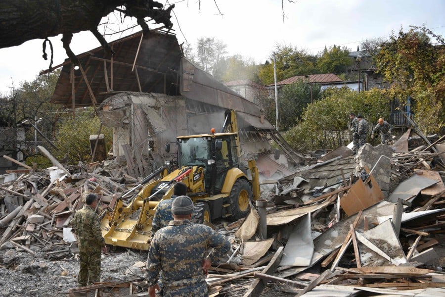 (File pic) Rescuers work among the debris of a destroyed house hit by a shelling during the ongoing military conflict between Armenia and Azerbaijan over the breakaway region of Nagorno-Karabakh, in the disputed province's capital of Stepanakert on November 6, 2020. (Photo by Karen MINASYAN / AFP) 