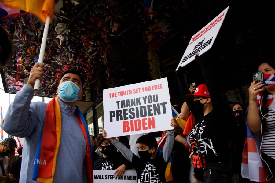 People hold "Thank You President Biden" signs as they protest outside of the Turkish Consulate on the anniversary of the Armenian genocide in a demonstration organised by the Armenian Youth Federation (AYF) on April 24, 2021 in Beverly Hills, California. - AFP pic