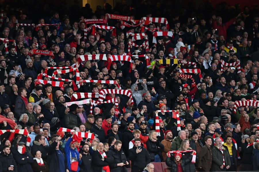 Arsenal fans sing ahead of kick-off in the English Premier League football match between Arsenal and Chelsea at the Emirates Stadium in London. (Photo by Glyn KIRK / AFP) 