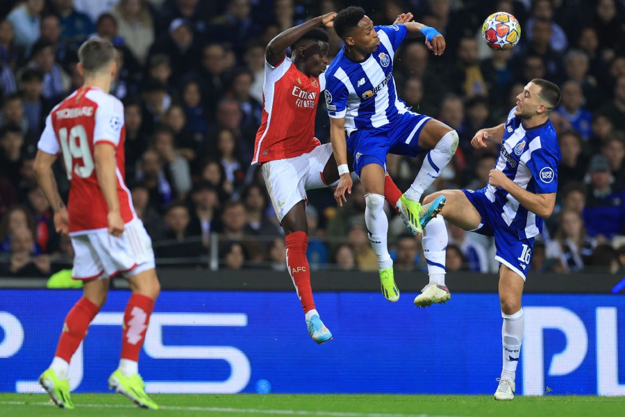 Arsenal's English midfielder Bukayo Saka and FC Porto's Brazilian defender Wendell (second from right) vie for a header next to FC Porto's Spanish midfielder Nico Gonzalez (right) during the UEFA Champions League last 16 first leg football match between FC Porto and Arsenal FC at the Dragao stadium in Porto. (Photo by PATRICIA DE MELO MOREIRA / AFP)