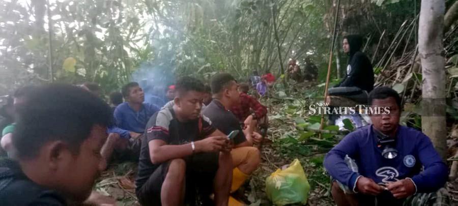 Orang Asli seen guarding the remains of the victim who was mauled by a tiger in Pos Pasik. - Courtesy pic