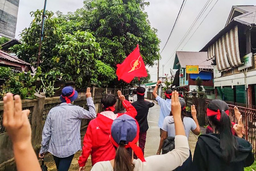 This handout photo taken and released by Dawei Watch on June 15, shows protesters making the three-finger salute during a demonstration against the military coup in Dawei. -AFP Pic/DAWEI WATCH