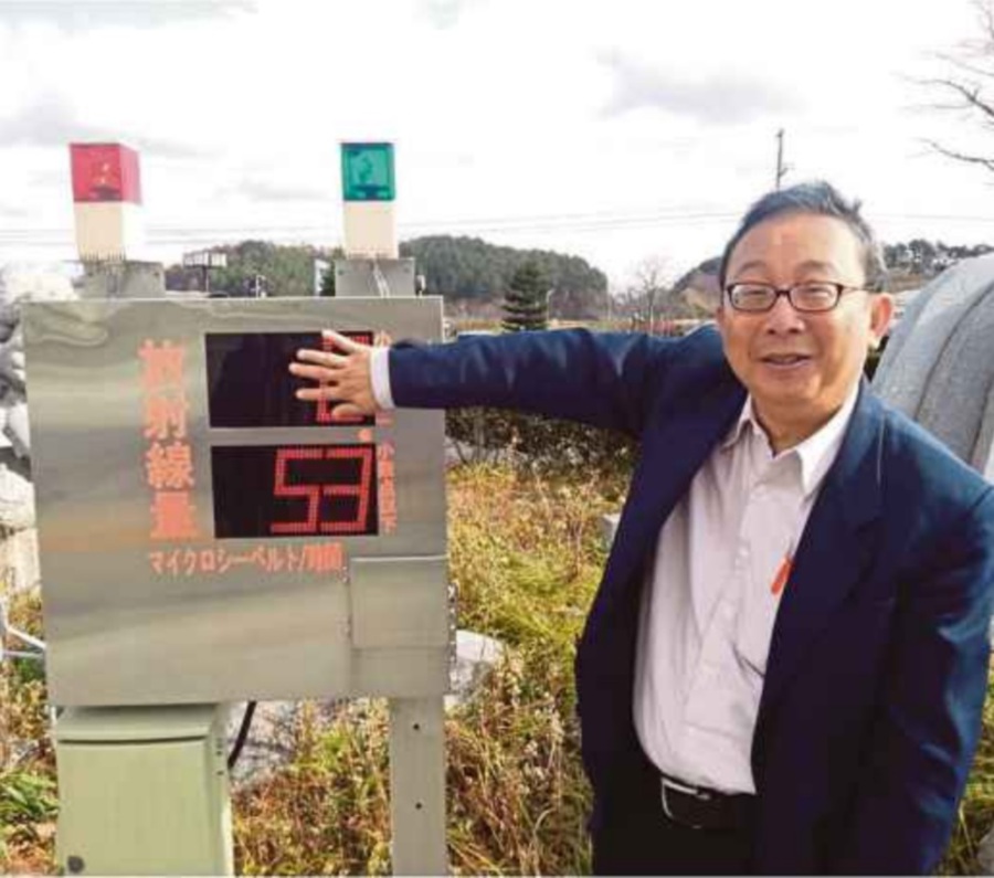 (File pix) Professor Dr Ng Kwan Hoong standing beside a radiation indicator installed 32km away from the Fukushima Daiichi Nuclear Power Plant in 2013. 