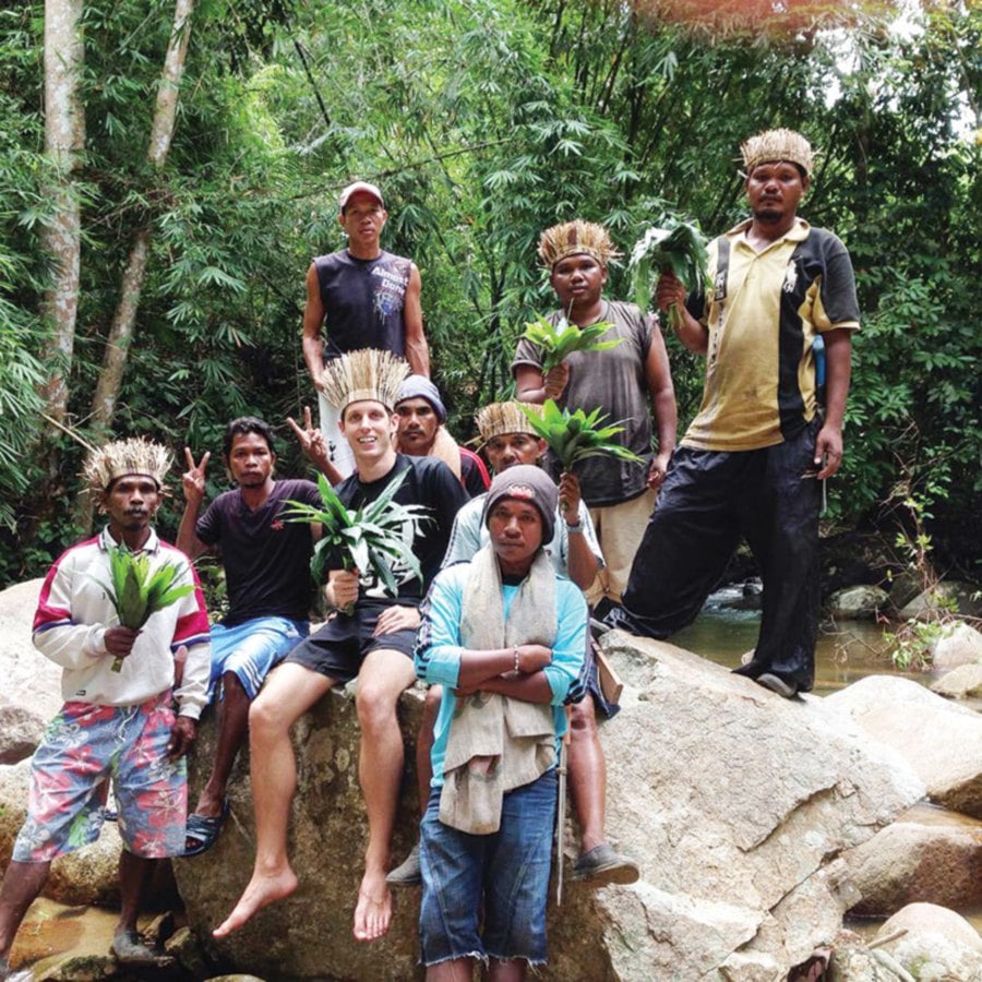 Bryan Cronan with Orang Asli parents.