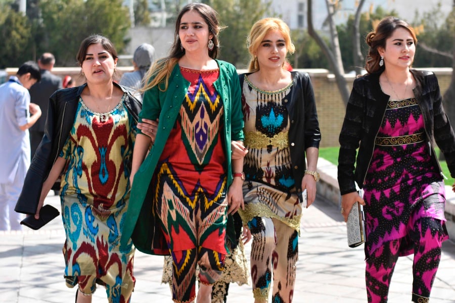 (File pix) A picture taken on March 19, 2017 shows Tajik women wearing the Atlas and other traditional dresses celebrating the spring Nowruz festival in Dushanbe. The authorities have campaigned against Arab-style head and face coverings like the hijab as part of a crackdown that has also included forced beard shavings. AFP Photo