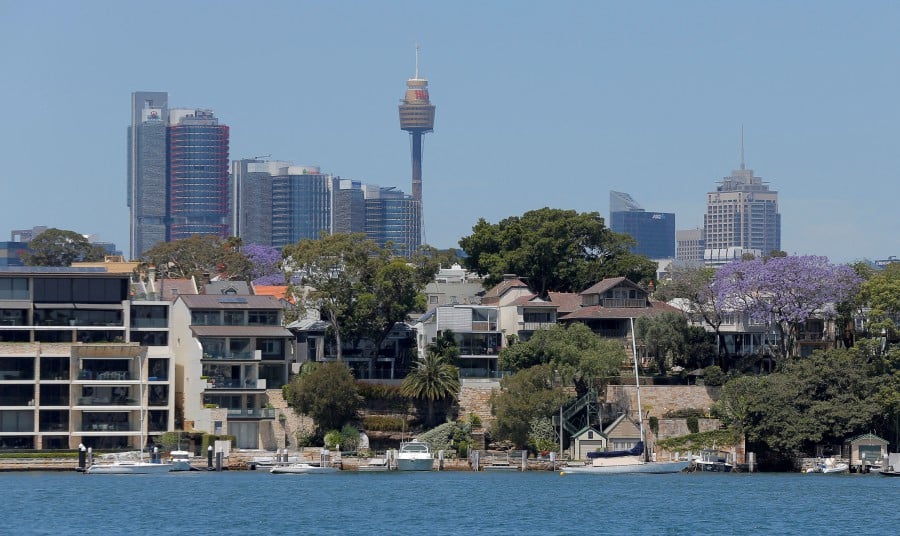 FILE PHOTO: FILE PHOTO: Sydney office buildings and commercial real estate appear behind Sydney waterfront properties in the suburb of Birchgrove, Australia. REUTERS/Jason Reed//File Photo