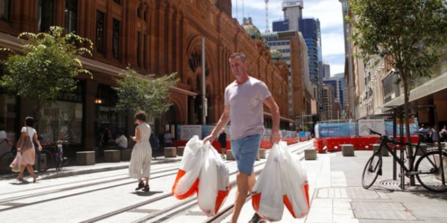 FILE PHOTO: A man carries several shopping bags as he walks along George Street in Sydney's central business district (CBD) Australia, February 5, 2018. REUTERS/Daniel Munoz/file photoREUTERS