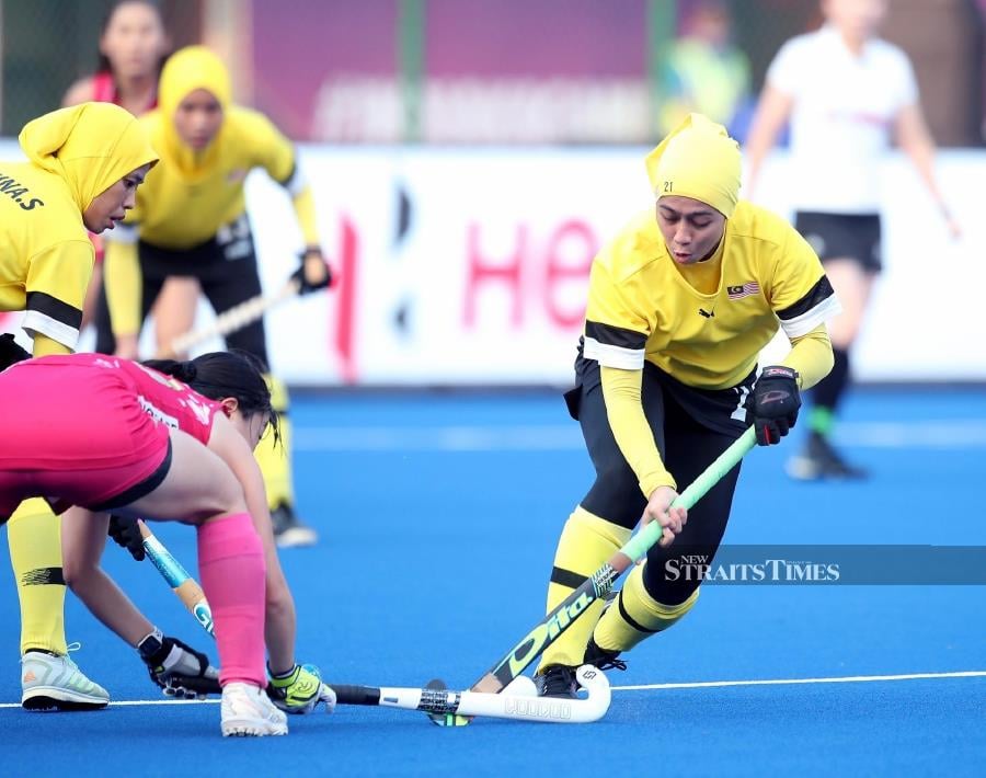 Malaysia women’s hockey players in action against Japan in the Asian Champions Trophy in Renchi.
