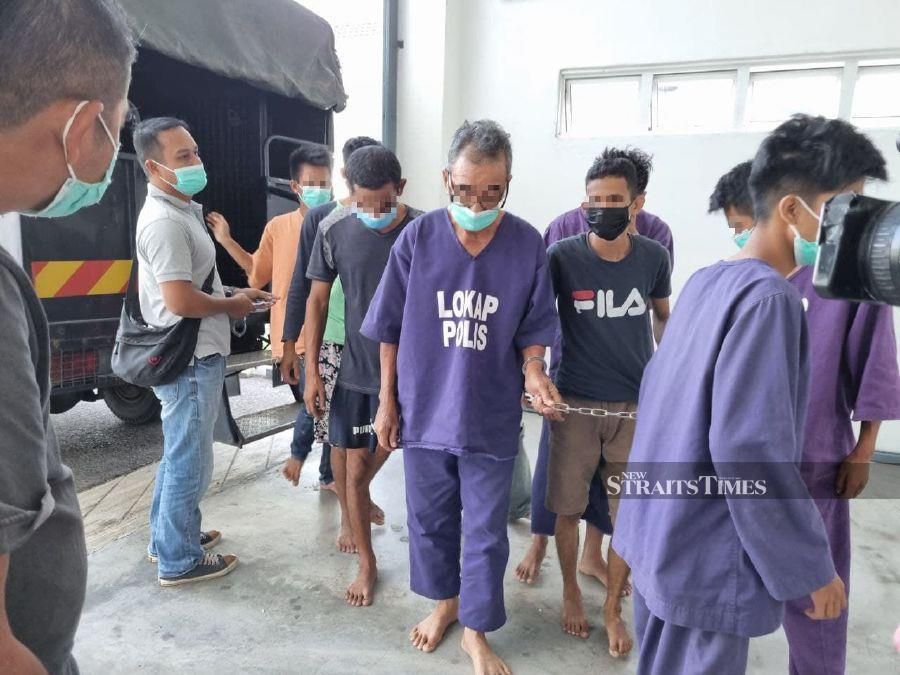 The suspect locally known as 'Ayah Su' (centre), was detained at his house in Tendong, Pasir Mas on Oct 15 soon after police received a report from the victim. - NSTP/SHARIFAH MAHSINAH ABDULLAH.