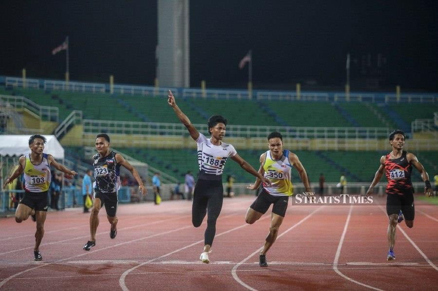 Azeem Fahmi crossing the finish line during the men's 100m final at the Malaysian Open on Saturday. - NSTP/LUQMAN HAKIM ZUBIR