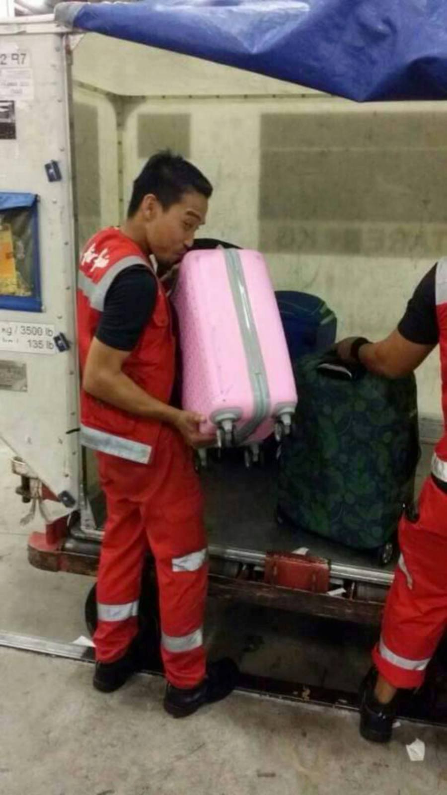 #Offbeat: AirAsia personnel literally kiss luggage following baggage