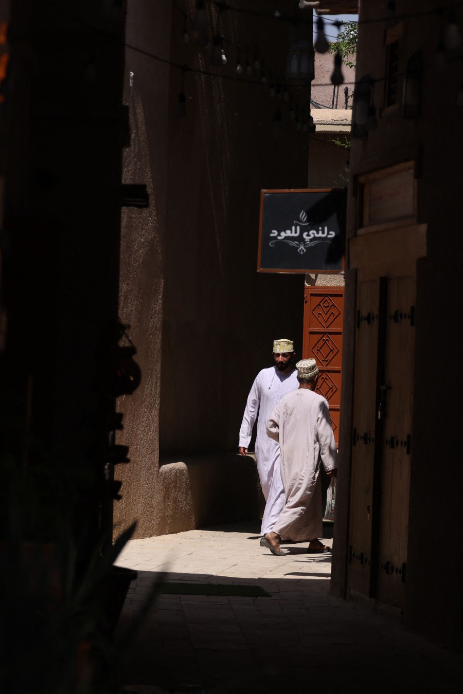 Omanis walk in Bahla Fort, one of four historical forts located at the foot of the Green Mountain highlands, and the only fort in the country designated a UNESCO Heritage Site, in Bahla. - AFP PIC