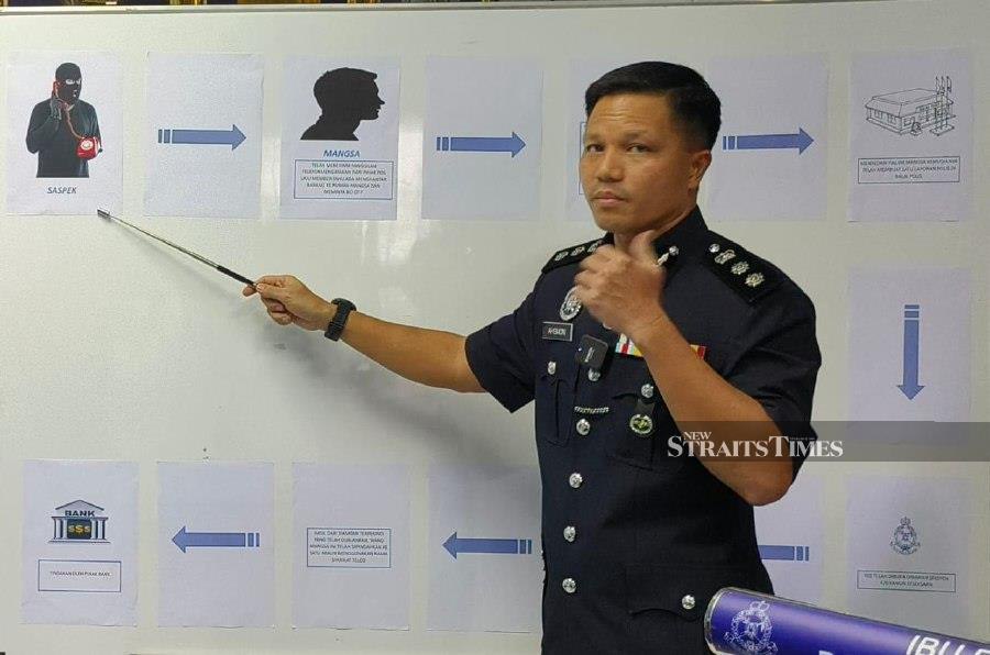 Kuching police chief Assistant Commissioner Ahsmon Bajah  gestures during a press conference at the  district police headquarters. -NSTP/NADIM BOKHARI