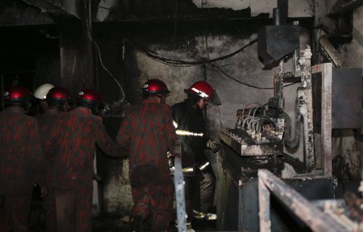 Bangladeshi firefighters inspect the damage inside a burnt plastic factory in Dhaka, Bangladesh. At least six people were reported killed in the fire Saturday evening. AP Photo