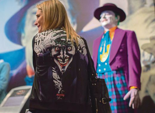 A reporter wears a sweater depicting "The Joker". REUTERS Photo