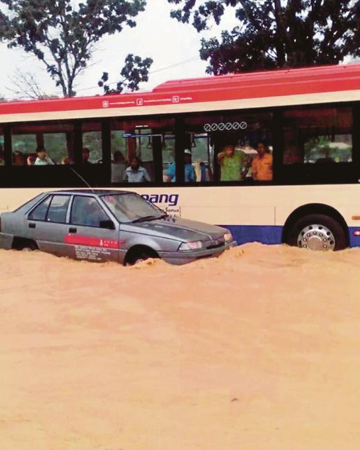 The flood situation in Bayan Baru on Wednesday after it rained for almost two hours. File pic.