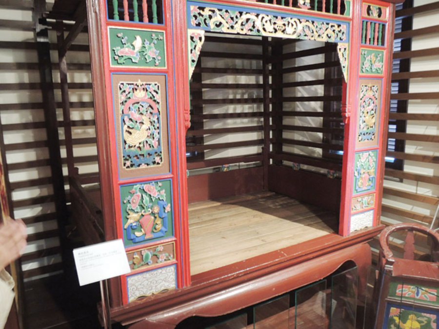 An elaborately carved nuptial bed.