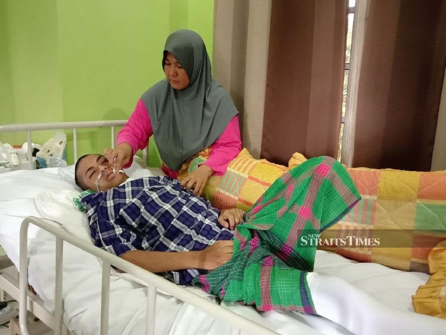 Wan Murni Wan Ngah, 46, from Kampung Jaba, Bukit Apit, in Ajil, here said that her son Muhammad Amirul Nazmi Sam, 20, was confirmed to have suffered a ruptured blood vessel after fainting on Dec 18. - NSTP/NAZDY HARUN 