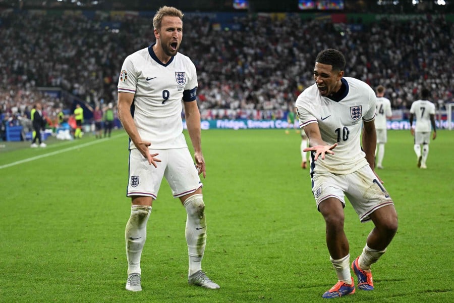  England's star forward Harry Kane (Left) and midfielder Jude Bellingham celebrate after Kane scored his team's second goal during the match against Slovakia at the Arena AufSchalke in Gelsenkirchen on Sunday (June 30). — AFP