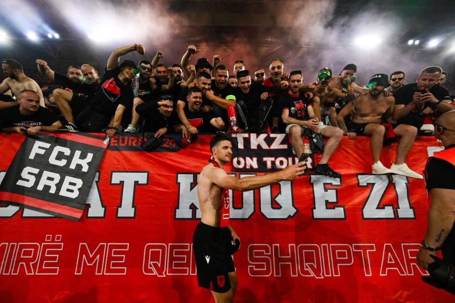 Albania’s Berat Djimsiti (centre) takes a smartphone photo with Albanian fans at the end of the Euro 2024 Group B match against Spain at the Duesseldorf Arena on Monday. - AFP PIC