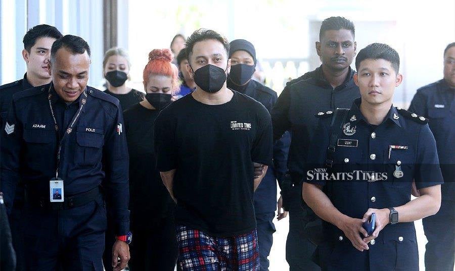 The man known as “Hot Daddy”, Hasli Ikhwan Arif Zul Hasli, 32, at the Kuala Lumpur Court Complex when he was first charged on Jan 26. He and female friends Norhidayah Mahadi, 24, and Norshazrina Md Zamri, 27, were brought to court again today to face more charges. NSTP file pic