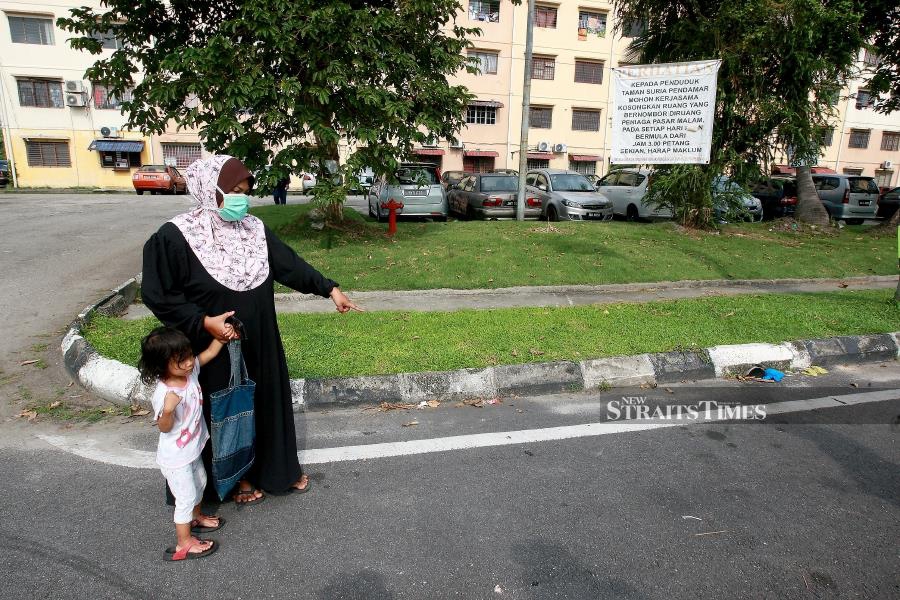 Norhashiqin Rosli showing the location where her daughter Nur Acha Dawina was attacked by two stray dogs. STR / FAIZ ANUAR