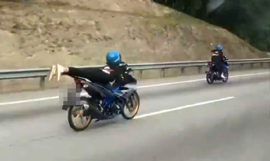The actions of three teenage girls performing 'Superman' stunts on the North-South Expressway led to trouble when they were arrested by the police yesterday. - Screengrab via social media
